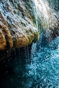 Close-up of water splashing on rock