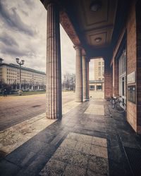 Empty road amidst buildings in city
