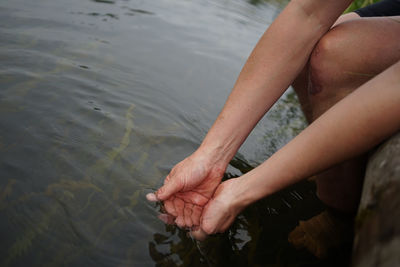 Low section of person on sea shore