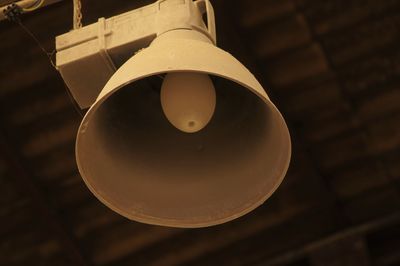 Low angle view of light bulb hanging from ceiling