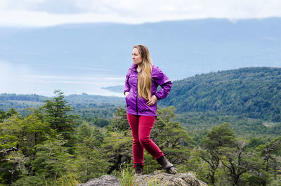 Hiker standing on rock at villarrica national park against sky