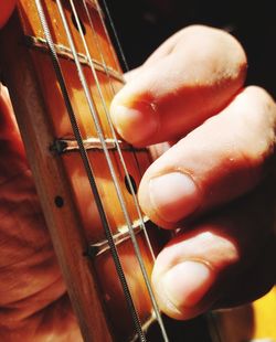 Close-up of hand playing guitar