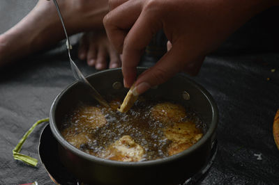 Midsection of person preparing food in kitchen