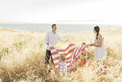 Family preparing picnic in meadow