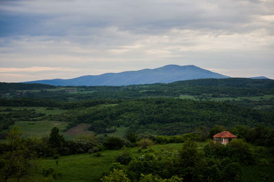 Scenic view of landscape and mountains against sky