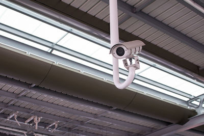 Low angle view of surveillance camera on ceiling