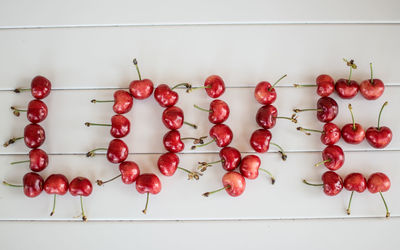 Love alphabets made with cherries on table