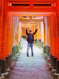 Full length of man standing outside temple in building