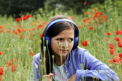 Portrait of girl with red flowers