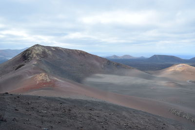 View of volcanic land against sky