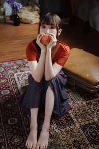 Low section of woman sitting on floor