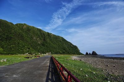 Road by sea against sky