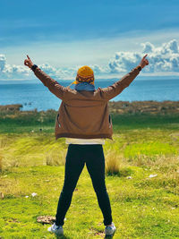 Rear view of man standing on field