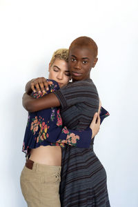 Portrait of lesbian couple against white background