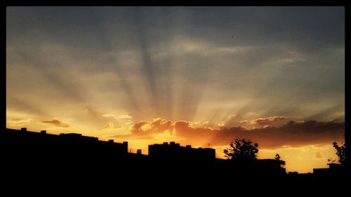 Silhouette of built structure at sunset