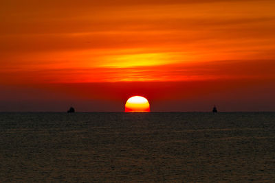 Scenic view of sea against romantic sky at sunset