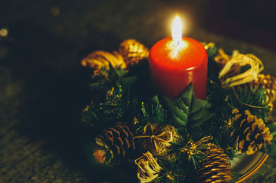 Close-up of lit tea light candle on table