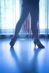 Low section of young woman standing on floor