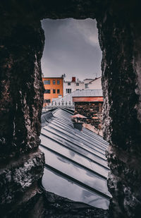 Canal amidst buildings against sky