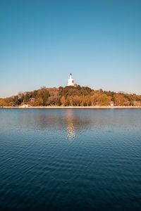 Lighthouse on building against clear blue sky