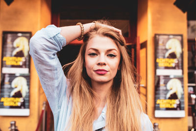 Portrait of young woman standing at home