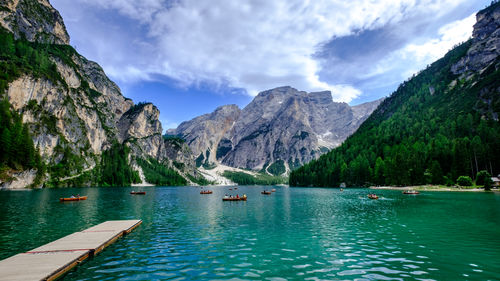 Scenic view of lake by mountains against sky