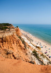 Scenic view of beach against clear blue sky