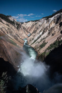 Scenic view of waterfall against sky