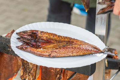 Smoked spiced mackerel fish ready to eat served in a plate, close up