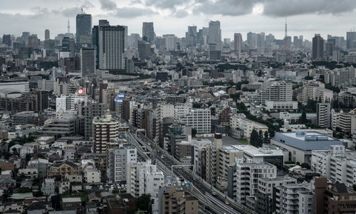 High angle view of modern buildings in city against sky