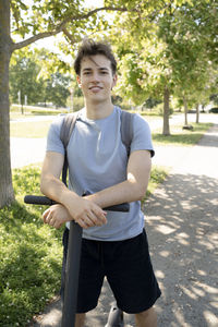 Portrait of young man holding umbrella