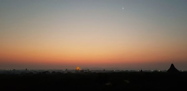 Silhouette of buildings against sky during sunset