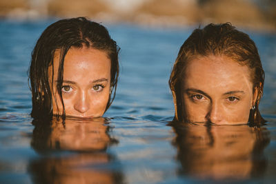 Portrait of smiling woman swimming in pool