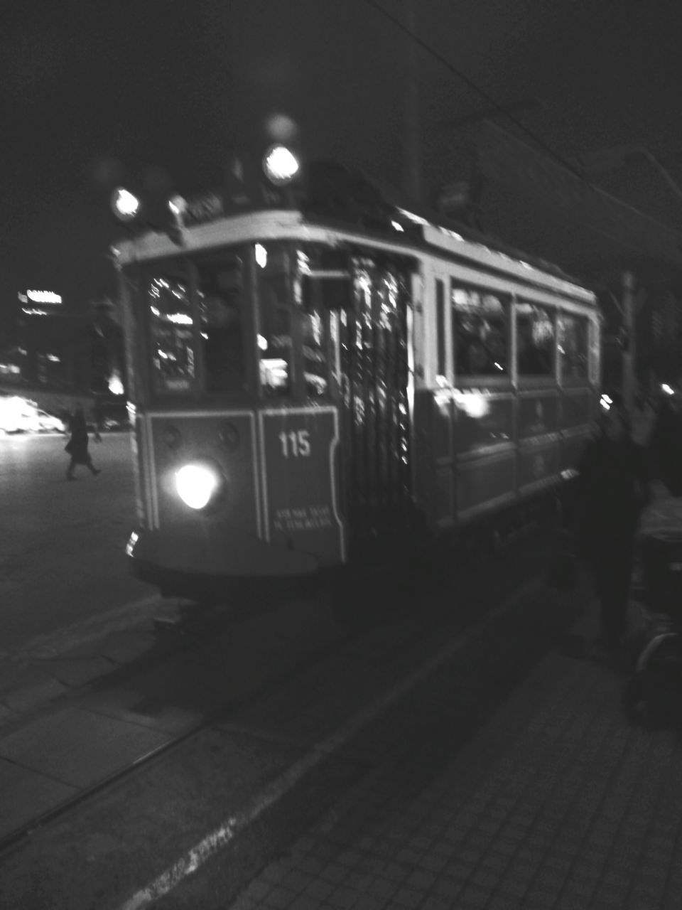 illuminated, night, transportation, mode of transport, land vehicle, public transportation, travel, railroad station platform, railroad station, street, incidental people, men, lighting equipment, city life, on the move, lifestyles, car, built structure