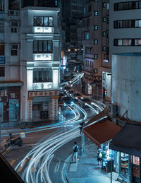 Illuminated city street and buildings at night