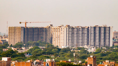 Buildings in city against clear sky