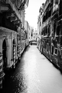 Walkway amidst buildings in city