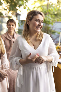 Portrait of smiling friends standing outdoors