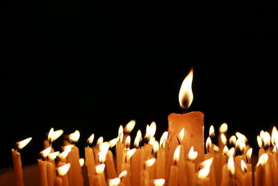 Close-up of lit candles in temple