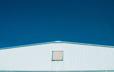 Low angle view of building against blue sky