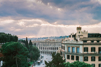 Buildings against cloudy sky