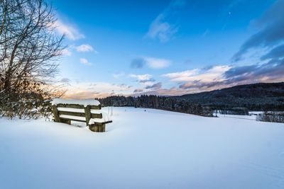 Scenic view of snow field against blue sky