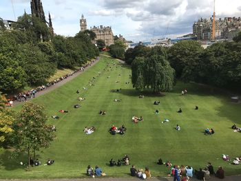 People in park against sky in city