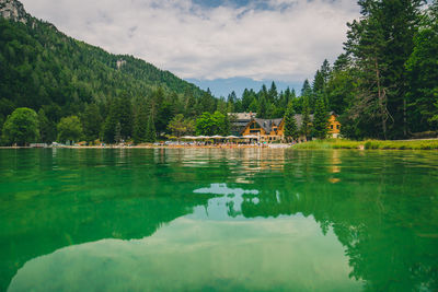 Scenic view of lake by trees against sky