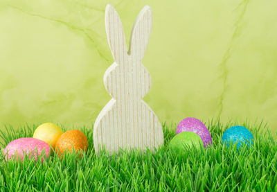 Easter bunny with multi colored eggs on grassy field