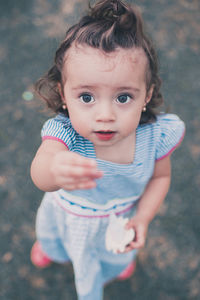 Portrait of cute girl standing on road