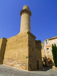 Low angle view of building against clear blue sky