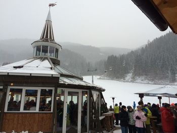 People on snow covered mountain against sky