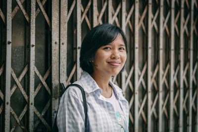 Portrait of smiling woman standing outdoors