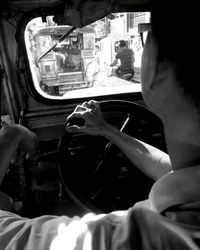 Cropped image of woman traveling in train